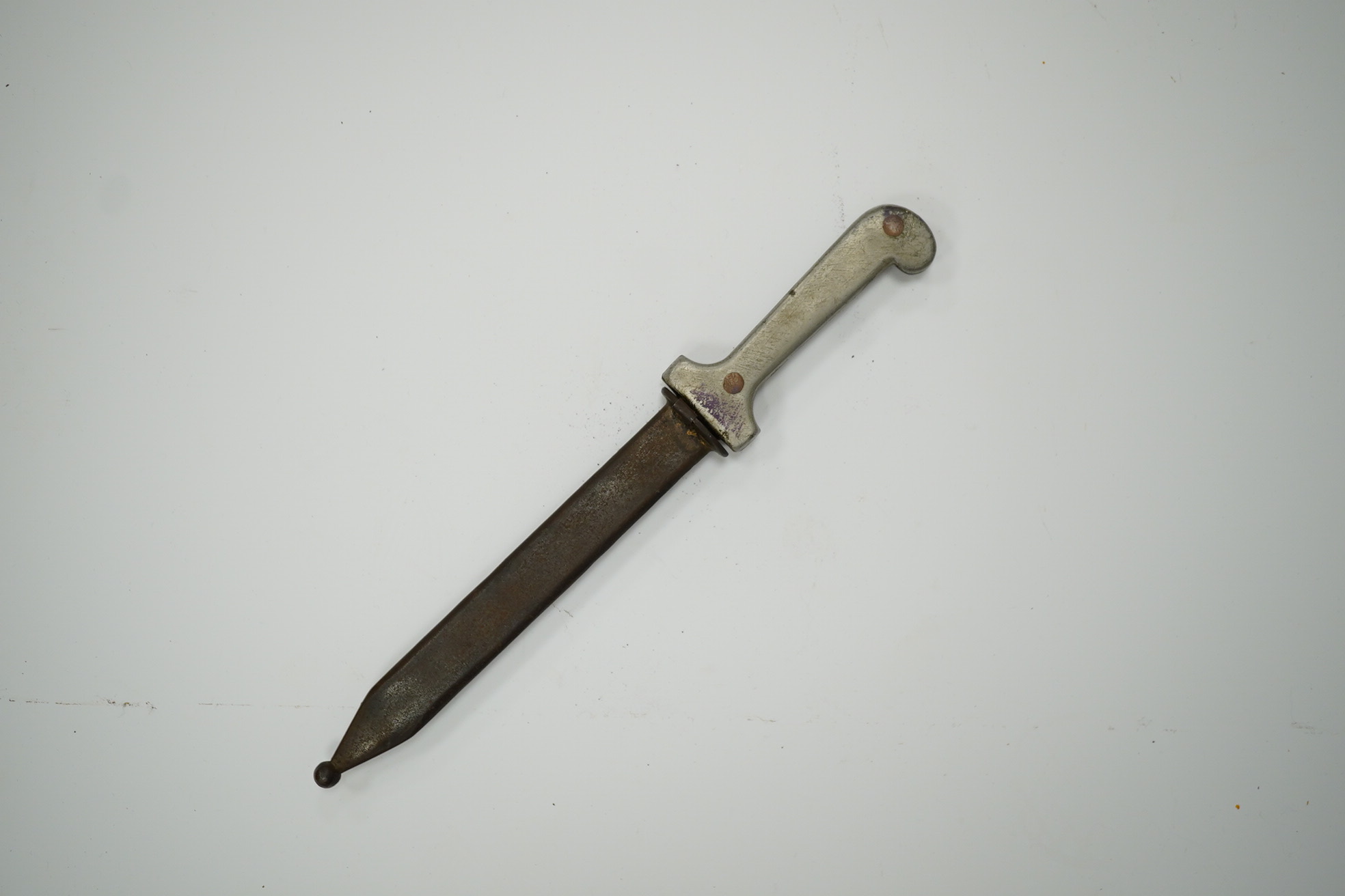 An Italian dagger, aluminium grips stamped Italia Casoli 1944, in its steel sheath, blade 16.5cm. Condition - fair